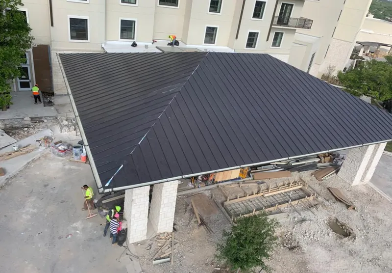 Metal roofing installation team working on a commercial building in Fruita